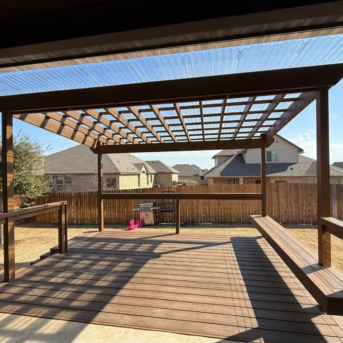 Trex deck and timber patio cover with translucent roof panels.